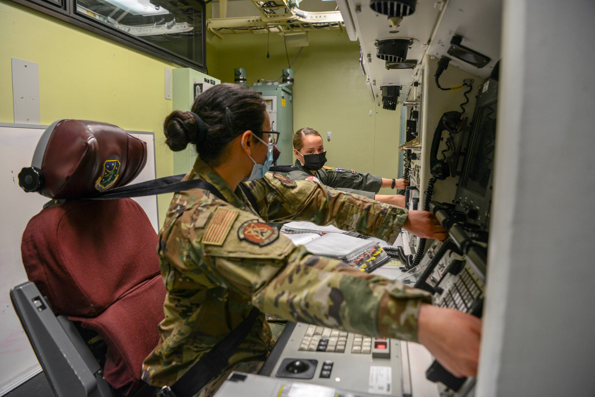 1st Lt. Janelle Hrycyk and 2nd Lt. April Hood, 740th Missile squadron missileers, simulate a key turn in the 91 Operations Support Squadron missile procedure trainer on March 8, 2021, at Minot Air Force Base, North Dakota.