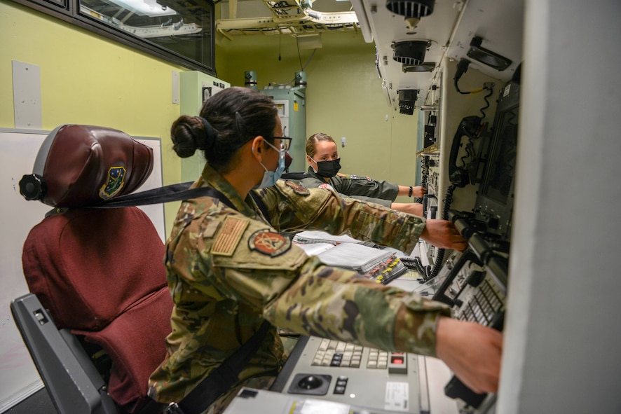 1st Lt. Janelle Hrycyk and 2nd Lt. April Hood, 740th Missile squadron missileers, simulate a key turn in the 91 Operations Support Squadron missile procedure trainer on March 8, 2021, at Minot Air Force Base, North Dakota.