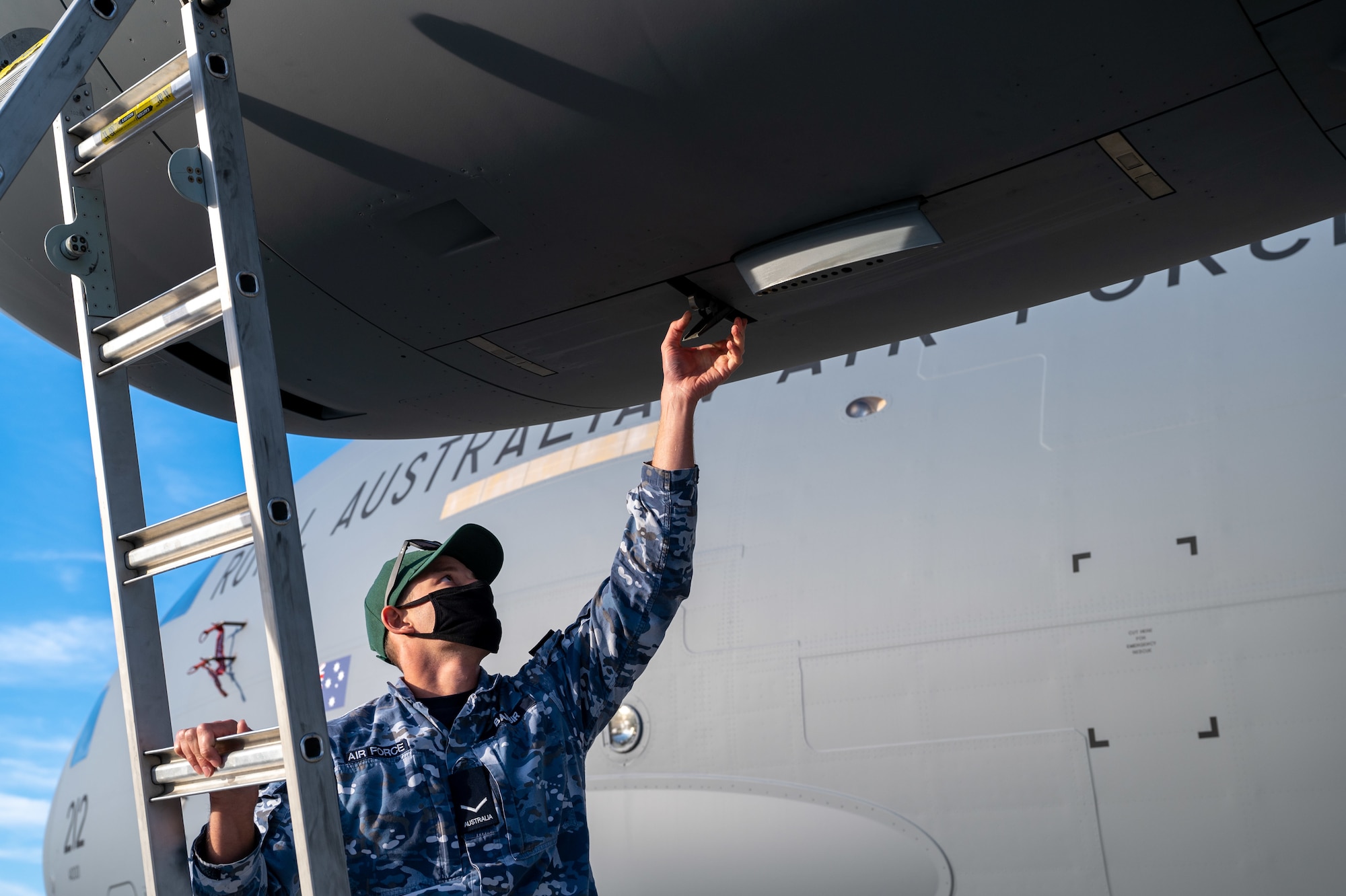 Leading Aircraftman Damian Babir, Royal Australian Air Force 36th Squadron aircraft technician, unlatches the engine accessory doors of a RAAF C-17 Globemaster III at Dover Air Force Base, Delaware, March 13, 2021. The U.S. and Australia maintain a robust relationship underpinned by shared democratic values, common interests and cultural bonds. The U.S.-Australia alliance is an anchor for peace and stability in the Indo-Pacific region and around the world. (U.S. Air Force photo by Airman 1st Class Faith Schaefer)