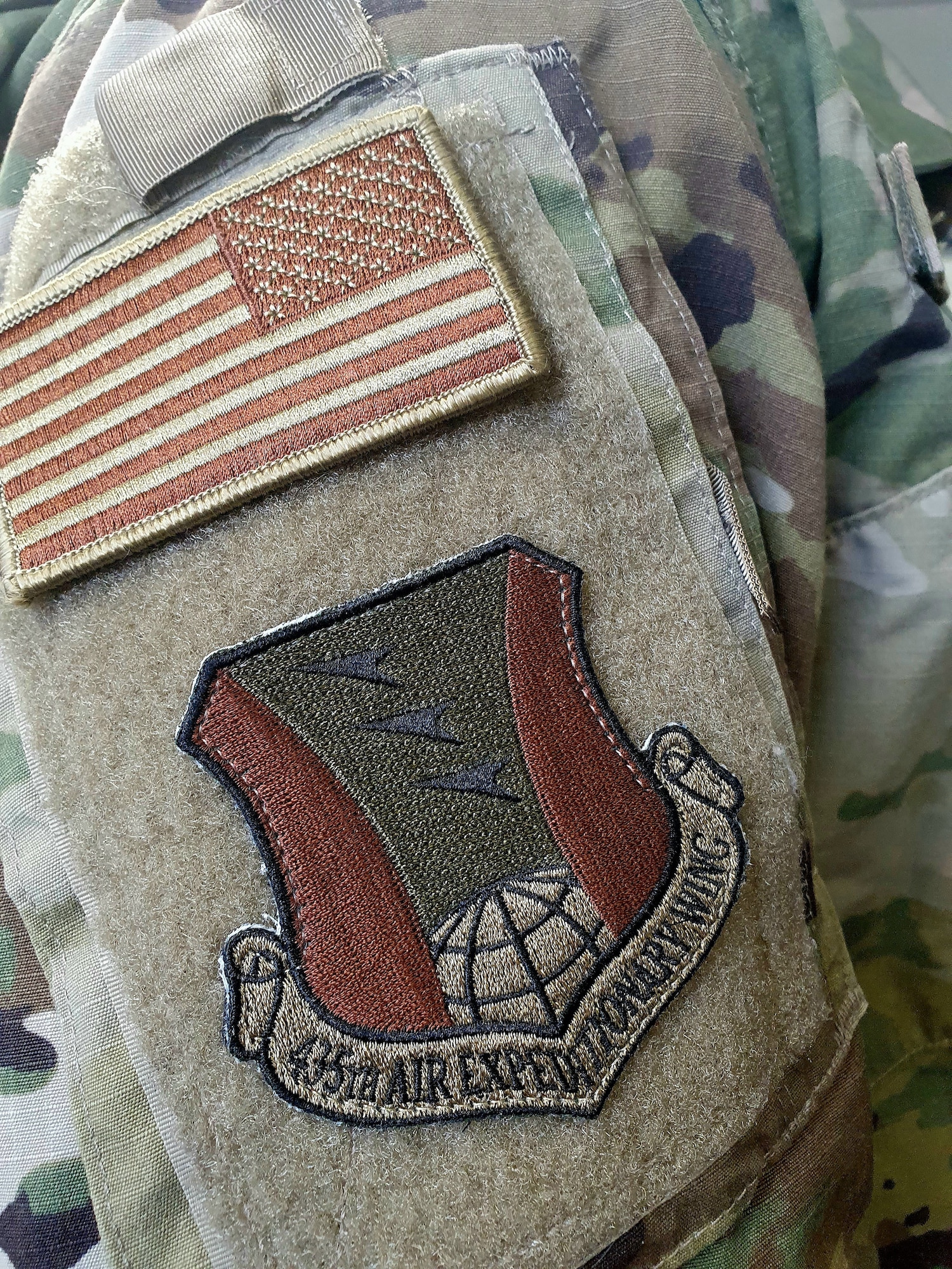 A U.S. Air Force Airman wears the 435th Air Expeditionary Wing patch at Ramstein Air Base, Germany, March 19, 2021. The 435 AEW provides combat Airpower and base operating support for operations across Africa. The 435 AEW’s continued success relies on commanders and first line supervisor’s ability to recruit, develop and retain individuals committed to the profession of arms and Air Force core values. (Courtesy photo)