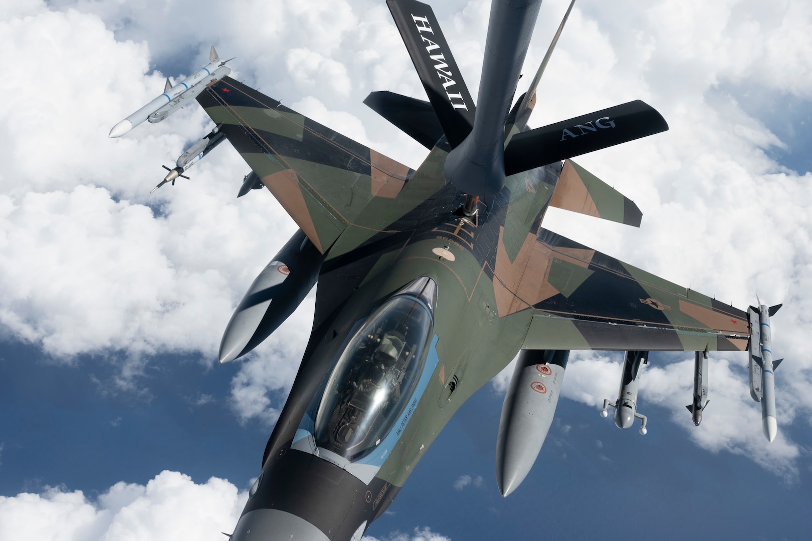 An F-16 Fighting Falcon from the 18th Aggressor Squadron receives fuel from a KC-135 Stratotanker from the 203rd Air Refueling Squadron March 10, 2021, near Oahu, Hawaii. The aircraft practiced combat tactics alongside fifth-generation F-22 Raptors from the 199th and 19th Fighter Squadrons for exercise Pacific Raptor. The Alaska-based F-16s, known as ‘Aggressors,’ simulate combat tactics.