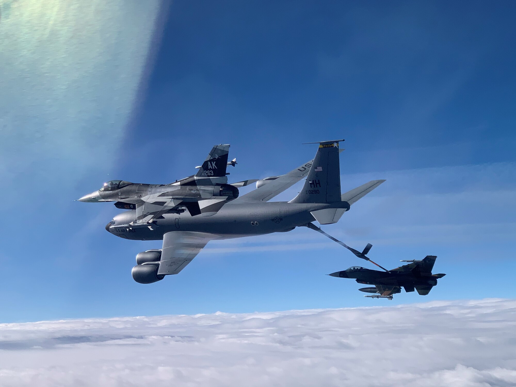 An F-16 Fighting Falcon from the 18th Aggressor Squadron receives fuel from a KC-135 Stratotanker from the 203rd Air Refueling Squadron March 10, 2021, near Oahu, Hawaii. The aircraft practiced combat tactics alongside fifth-generation F-22 Raptors from the 199th and 19th Fighter Squadrons for exercise Pacific Raptor. The Alaska-based F-16s, known as ‘Aggressors,’ simulate combat tactics likely to be faced in the event of an air-to-air battle.