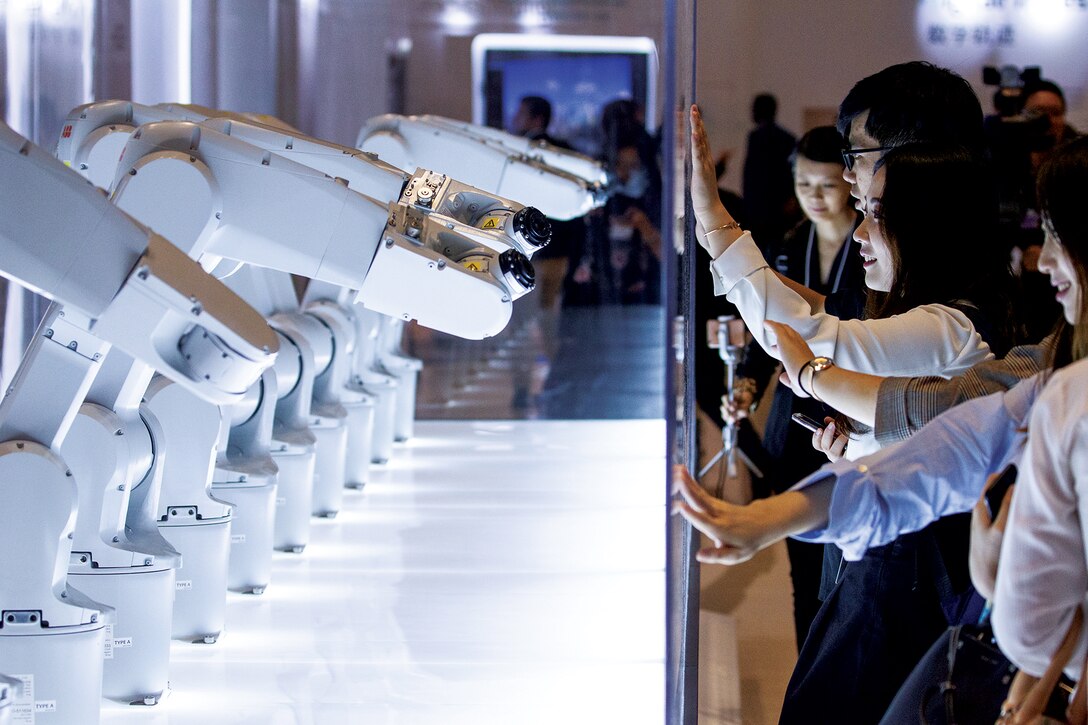 Participants interact with robots at the World Economic Forum - Annual Meeting of the New Champions in Tianjin, People’s Republic of China 2018.” (World Economic Forum photo by Greg Beadle, September 18, 2018)