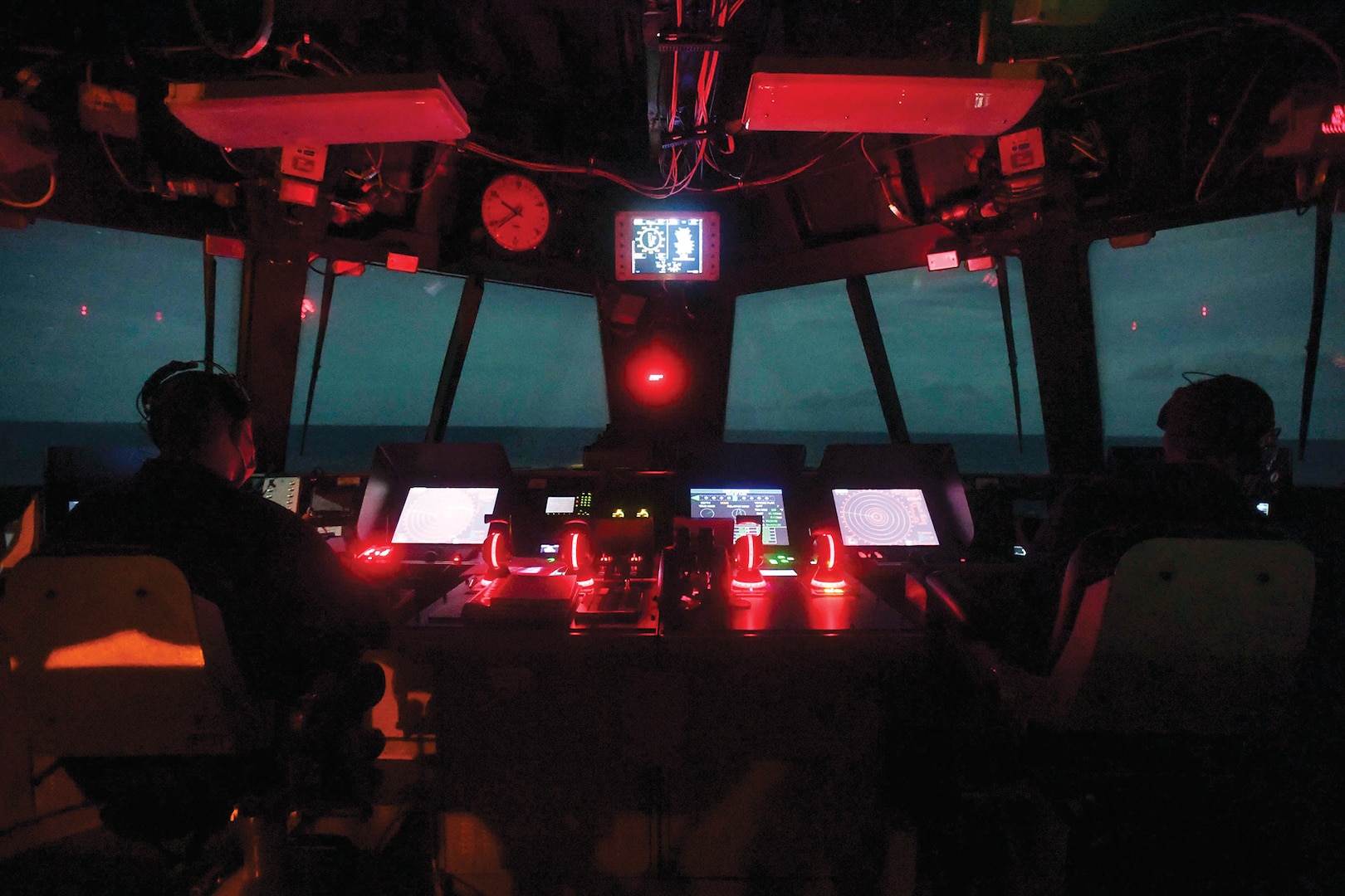 Navy Lt. j.g. Justin Bishop and Chief Petty Officer David Thompson keep watch in the navigation bridge aboard the USS
Sioux City in the Caribbean Sea.” December 21, 2020 (Photo by Navy Seaman Juel Foster, Nov. 23, 2020)