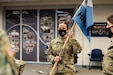 Chief Warrant Officer 4 Ellen Smith of Joint Force Headquarters, Pennsylvania National Guard holds a guidon during a change-of-command ceremony for Headquarters and Headquarters Company, White House Communications Agency on Jan. 28, 2021, at Joint Base Anacostia-Bolling in Washington, D.C. Smith, who served as the company's first commander, relinquished command of HHC to another member of the Pa. National Guard.