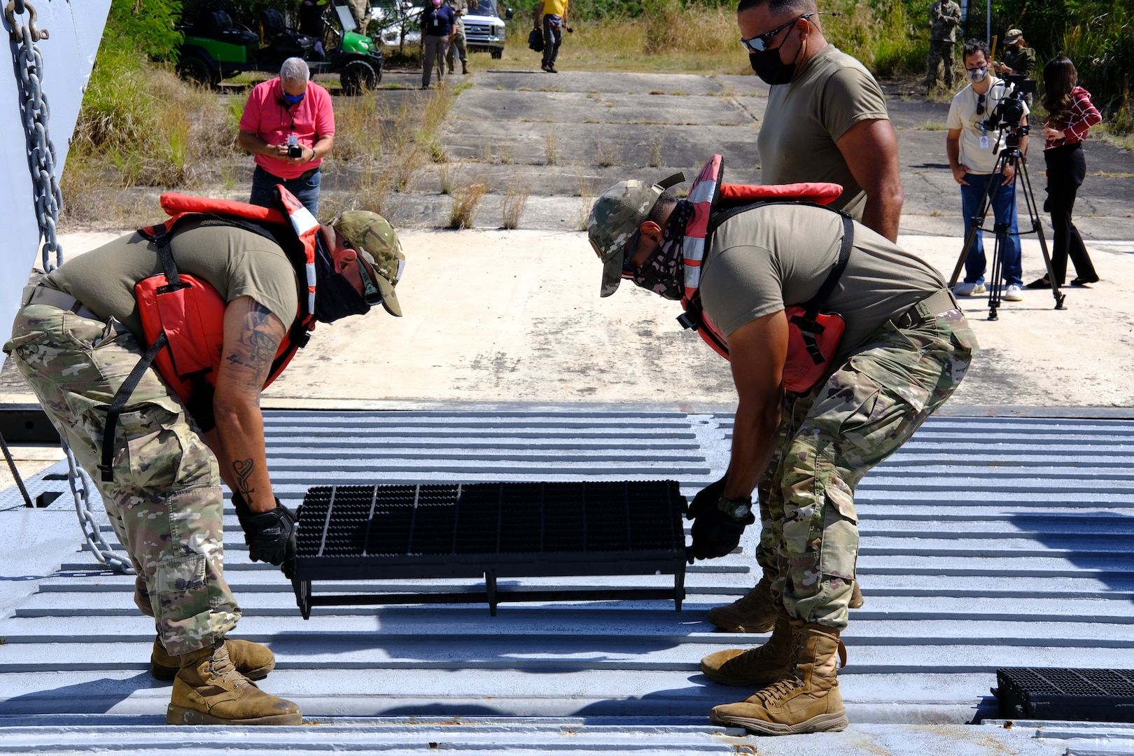 Puerto Rico National Guard Soldiers assigned to Joint Task Force - Puerto Rico set up a railing for vehicle transport on the Mechanized Landing Craft at the Maritime Transport Authority Port at Ceiba, Puerto Rico, March 15, 2021. The PRNG is helping transport medical supplies and other vital goods during the COVID-19 pandemic.