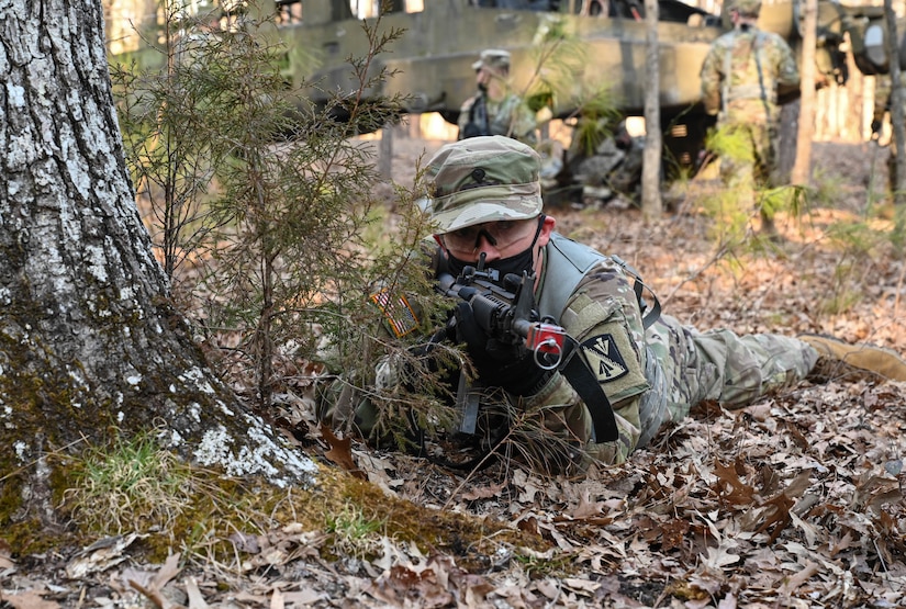 A U.S. Army Soldier scans his sector of fire while his battle buddies recover sensitive items from a simulated downed aircraft during a training exercise at Joint Base Langley-Eustis, Virginia, March 10, 2021.