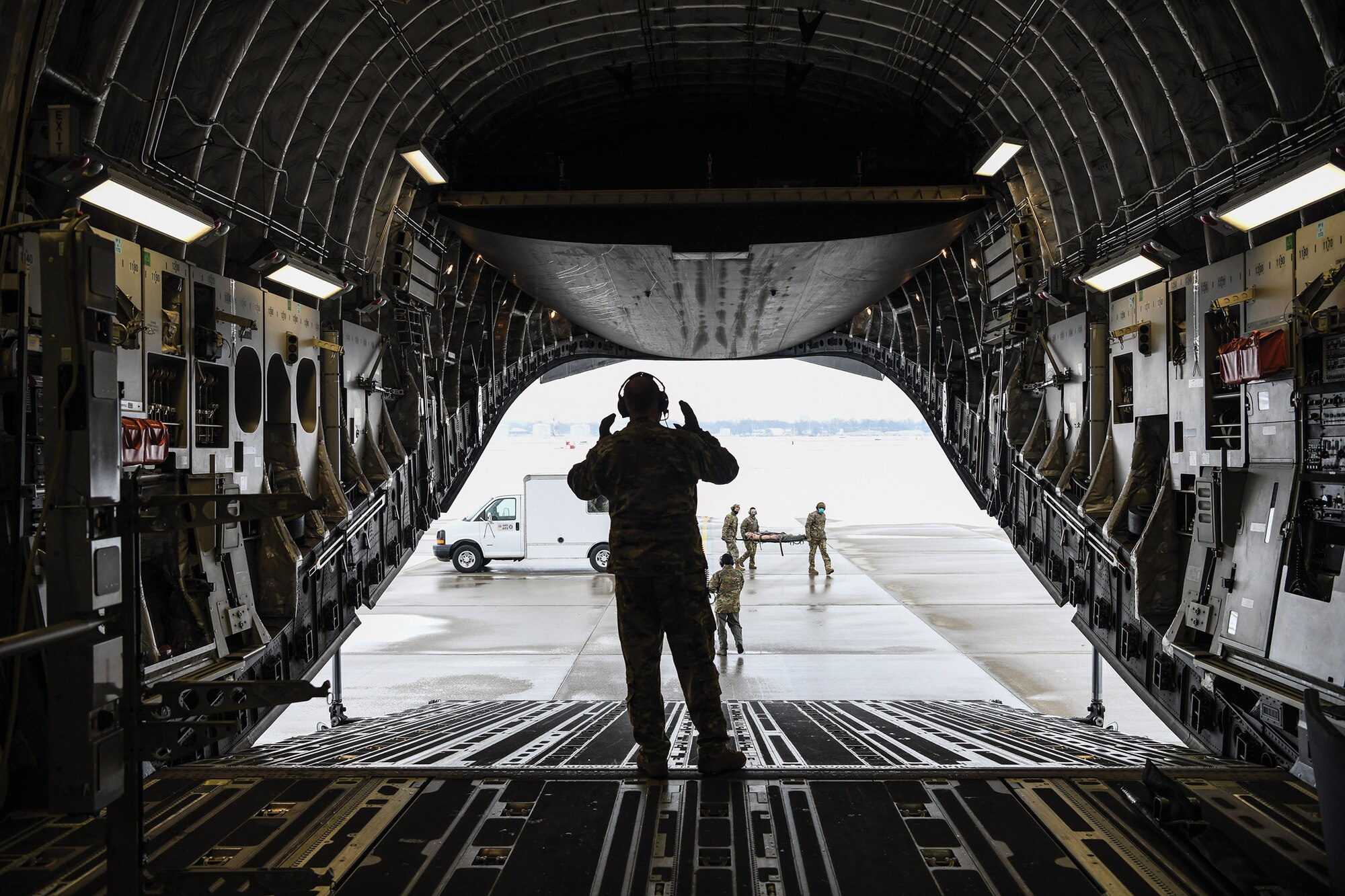 Members of the 445th Aeromedical Evacuation Squadron load a 445th Airlift Wing C-17 Globemaster III with medical equipment during a local mission training sortie, Feb. 11, 2021. The cargo area of the C-17 can hold 36 litters and 54 ambulatory patients and attendants with a basic crew of five, two flight nurses and three medical technicians for aeromedical evacuations.