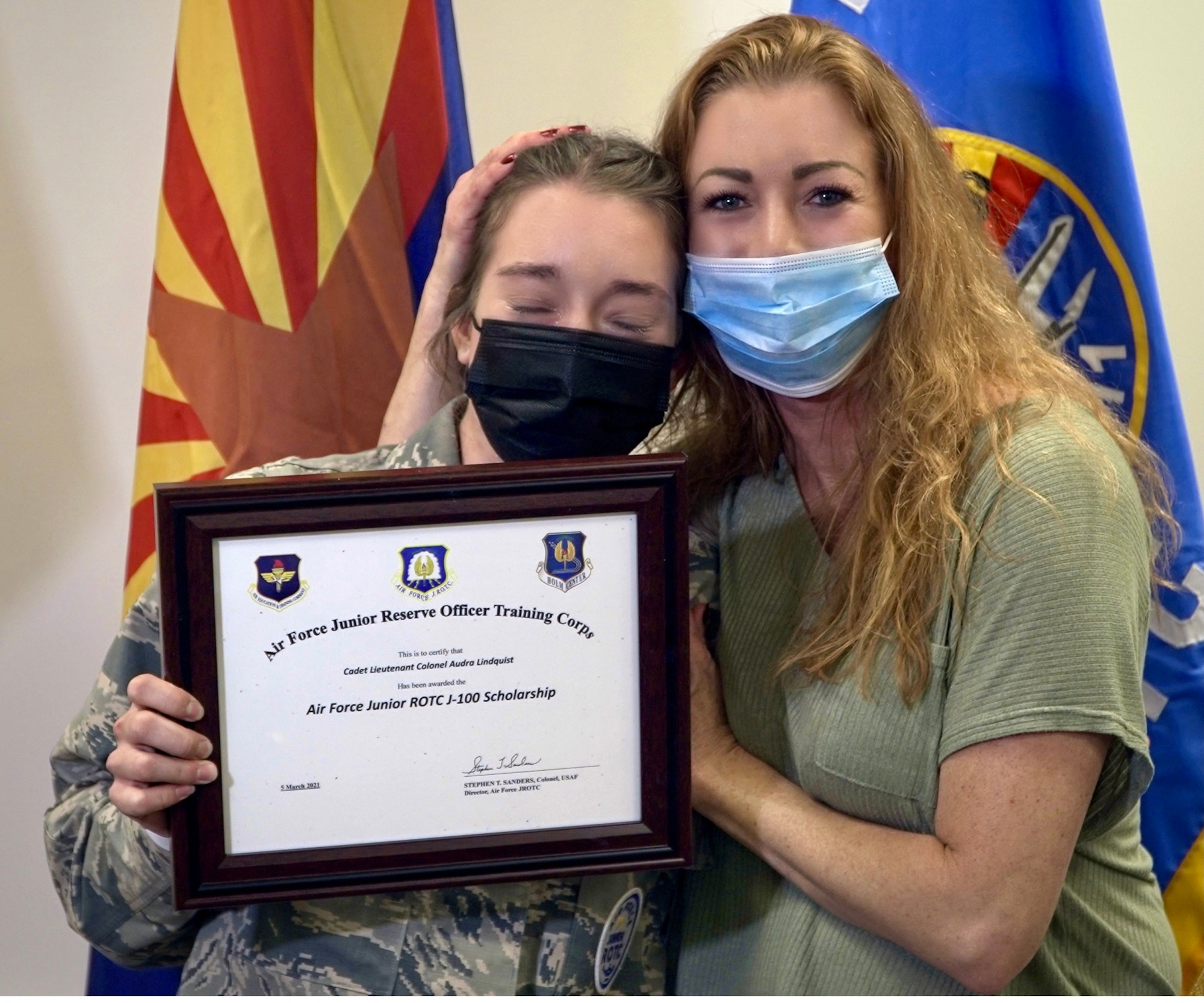 Cadet Audra Lindquist, a senior at Shadow Mountain High School, Phoenix, AZ, Air Force Junior ROTC Unit AZ-911, is congratulated by her mother, Amira Keuhn, aerospace instructors and school leadership for being a recipient of The J-100 AFJROTC Character-in-Leadership Scholarship.