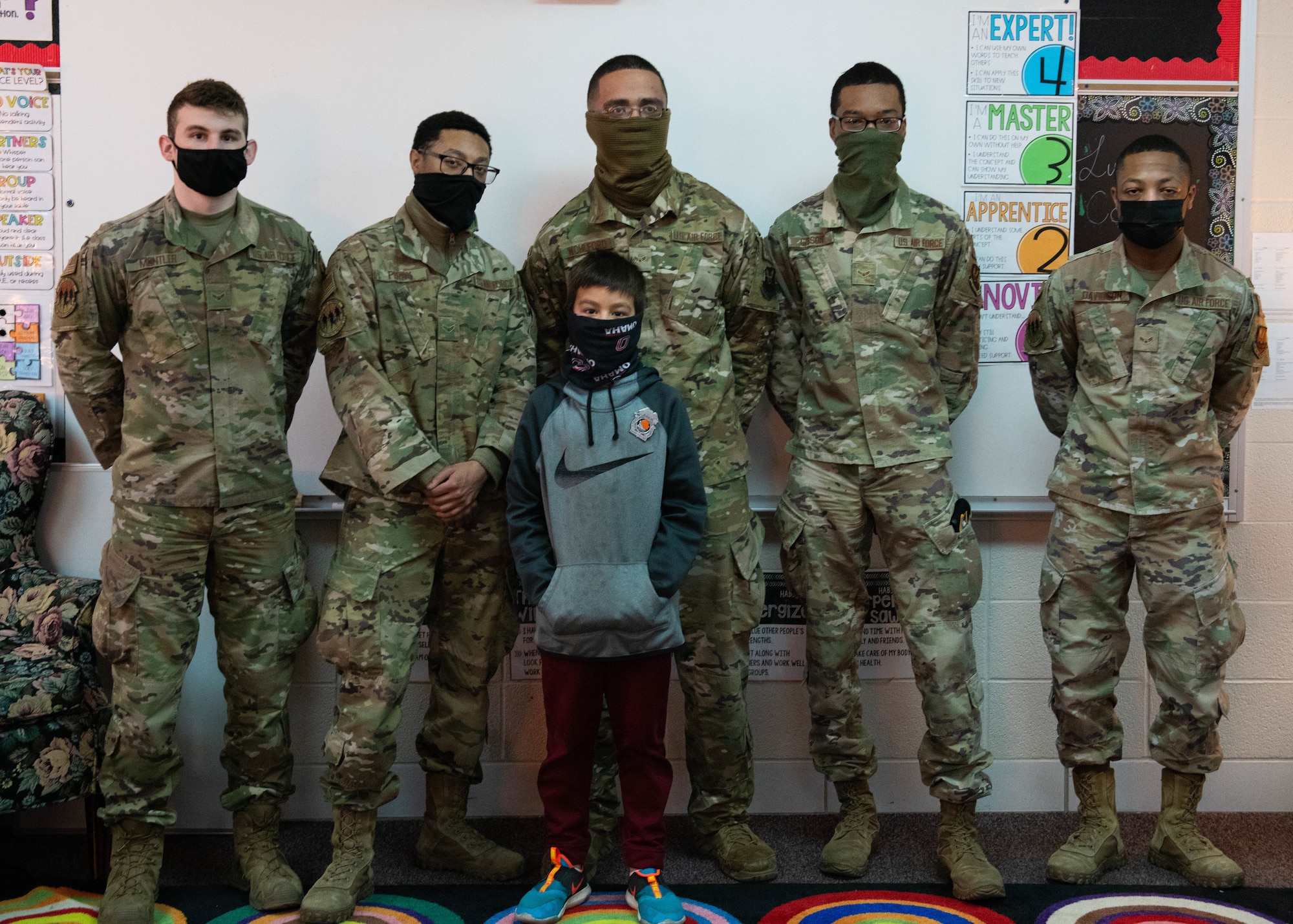 509th Security Forces Squadron Airmen, stand with Omar, an elementary student at Whiteman Air Force Base, Missouri, on Feb. 26, 2021. Omar delivered a letter to security forces in
order to express his admiration for the career field. (U.S. Air Force Photo by Airman 1st Class Devan Halstead)