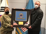 A soldier receives a plaque.