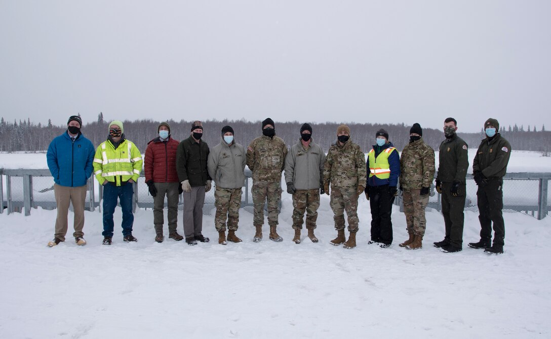 Maj. Gen. William Graham, deputy commanding general of civil and emergency operations for the U.S. Army Corps of Engineers (sixth from left), stands on the control works of the Moose Creek Dam with representatives of the Chena River Lakes Flood Control project on Feb. 19 near North Pole.