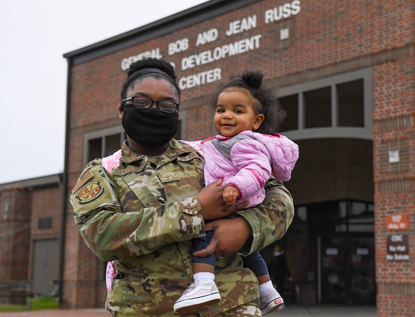 U.S. Air Force Airman 1st Class Jennifer Jolicoeur-Jay, 633rd Force Support Squadron retirement separations technician, carries her daughter, Julyssa Jay, 11 months, outside of the General Bob and Jean Russ Child Development Center at Joint Base Langley-Eustis, Virginia, March 17, 2021.