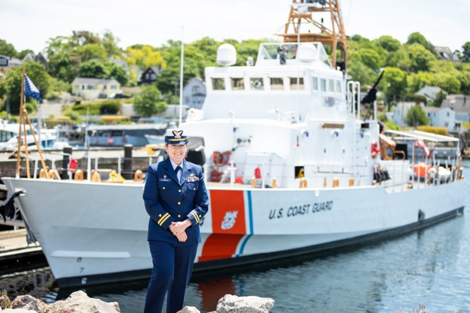 Lt. Tara Pray stands in front of U.S. Coast Guard Cutter Key Largo homeported in historic Gloucester, Massachusetts. (U.S. Coast Guard Photo)