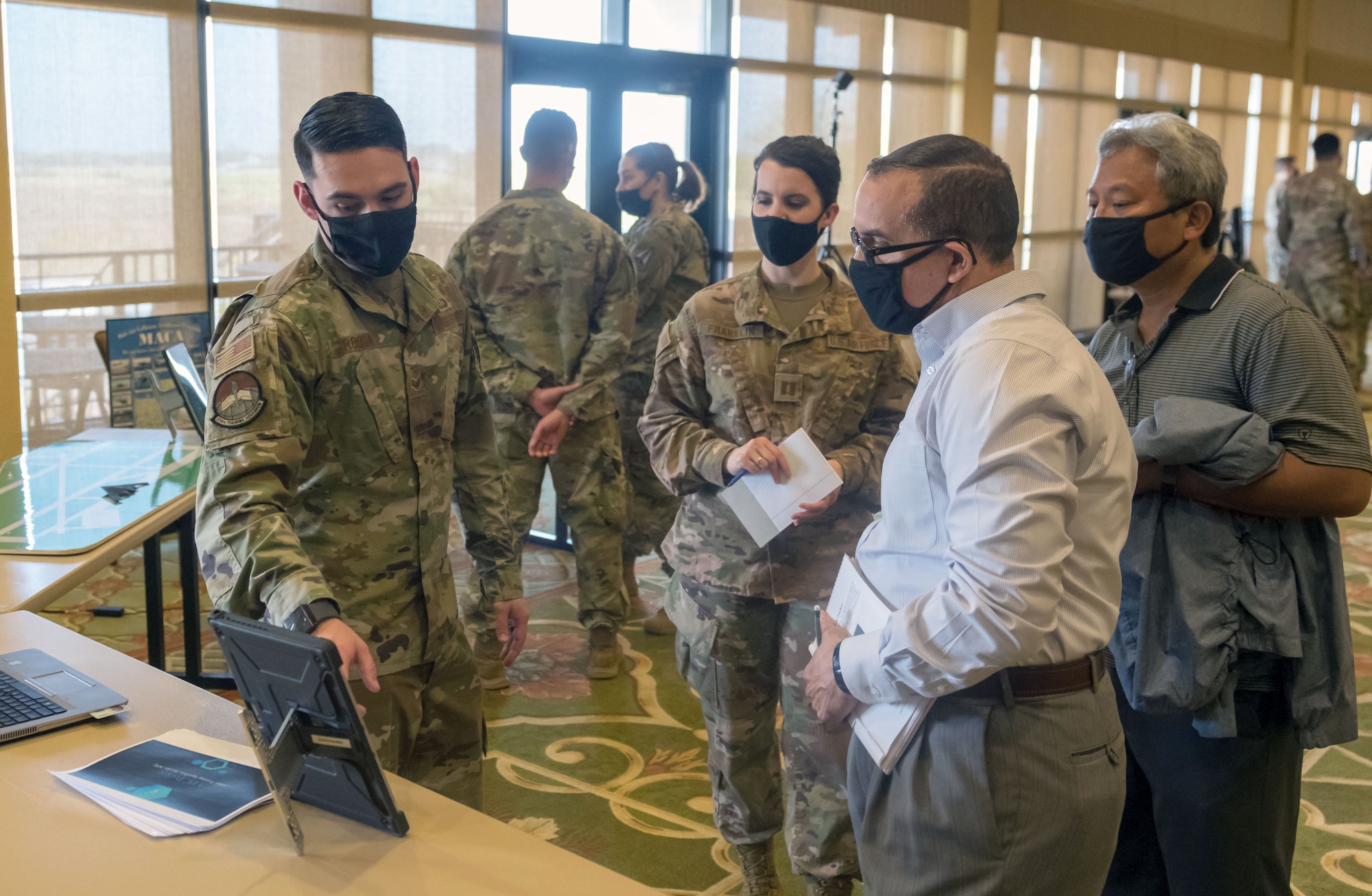 U.S. Air Force Staff Sgt. Jeremy Roosa, 334th Training Squadron instructor, briefs Keesler personnel about the Air Traffic Control Pocket App capabilities during the 81st Training Group Next Level Showcase at the Bay Breeze Event Center on Keesler Air Force Base, Mississippi, March 17, 2021. The showcase was the crowning point of the 81st TRG's past year technological and innovating think tank. (U.S. Air Force photo by Andre' Askew)