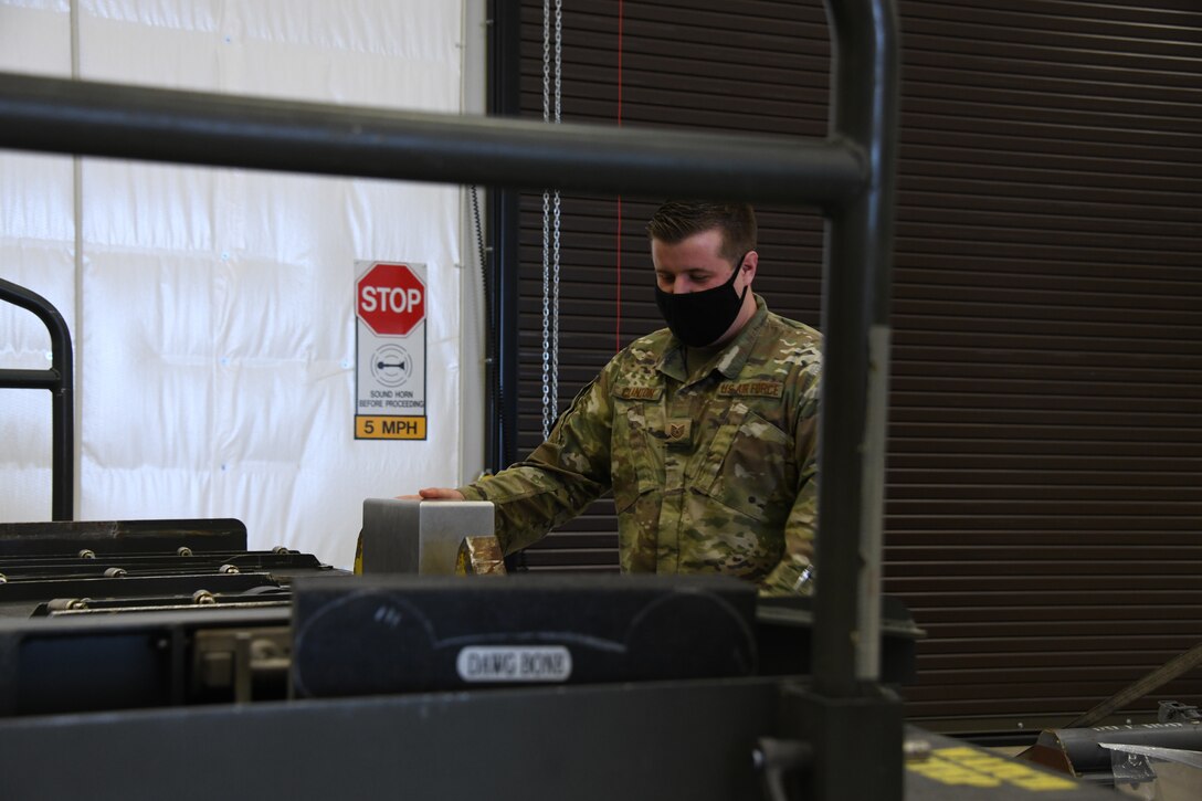 Tech Sgt. Daniel Clanton, 92nd Logistics Readiness Squadron air transportation operator, demonstrates how to use the “Dawgbone” on an equipment trailer at Fairchild Air Force Base, Washington. The “Dawgbone” is an assistive tool that can be placed on the bed of any trailer or cargo loading vehicle, allowing Airmen to safely load and unload pallets of cargo more effectively. (U.S. Air Force photo by Senior Airman Breanne White)