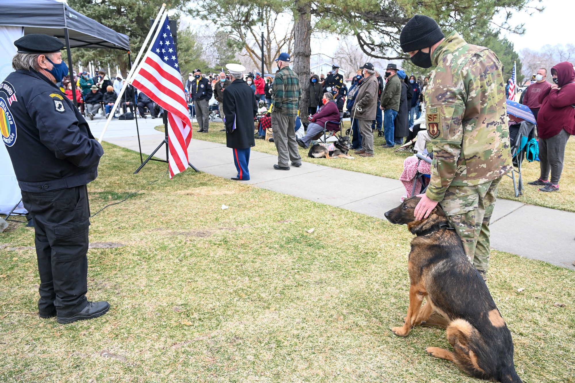 Staff Sgt. Tyler Hopkins,  75th Security Forces Squadron at Hill Air Force Base, Utah, pets Military Working Dog Bastas, while attending the Vietnam Veterans War Dog Memorial dedication ceremony Mar. 13, 2021, in Layton, Utah. The memorial features a monument honoring war dogs that served during a time when they were forgotton. (U.S. Air Force photo by Cynthia Griggs)