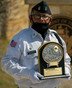 Manny Mendoza, Fort Sam Houston Memorial Services Detachment commander, poses with a commemorative plaque at the Fort Sam Houston National Cemetery in San Antonio March 15. The plaque was presented to commemorate the 40,000th funeral service conducted by the detachment.