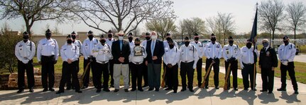 Members of the Fort Sam Houston Memorial Services Detachment, along with Robert C. (Bob) Winkler and Graham L. Wright III, assistant directors of the U.S. Department of Veterans Affairs National Cemetery Administration Fort Sam Houston National Cemetery, pose for a photo at the Fort Sam Houston National Cemetery in San Antonio March 15. A ceremony was held to commemorate the detachment’s 40,000th funeral service.