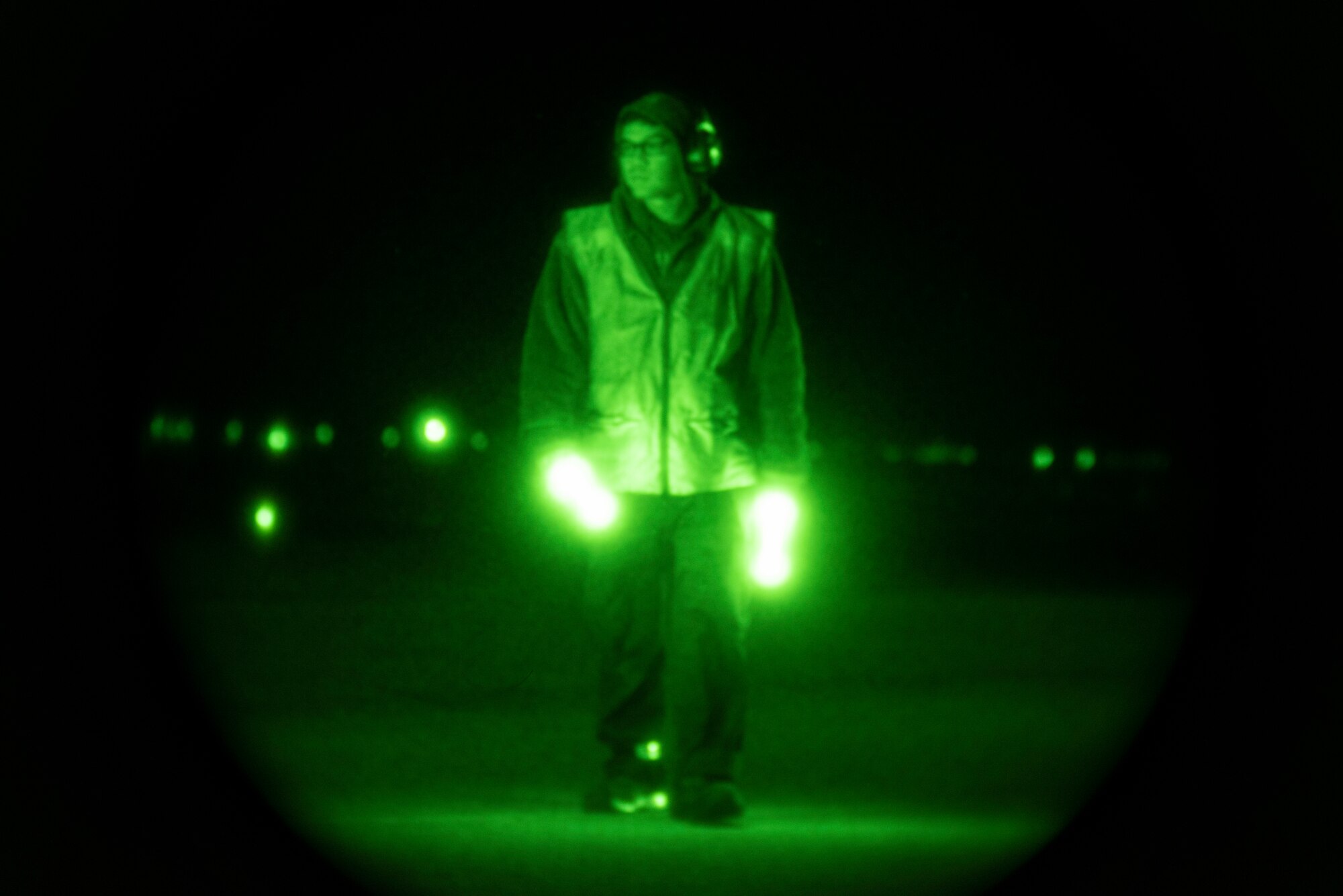 A 9th Expeditionary Bomb Squadron crew chief awaits to marshal a B-1B Lancer at Ørland Air Force Station, Norway, March 16, 2021. Crew chiefs are responsible for conducting the necessary aircraft maintenance to ensure planes are mission capable. (U.S. Air Force photo by Airman 1st Class Colin Hollowell)