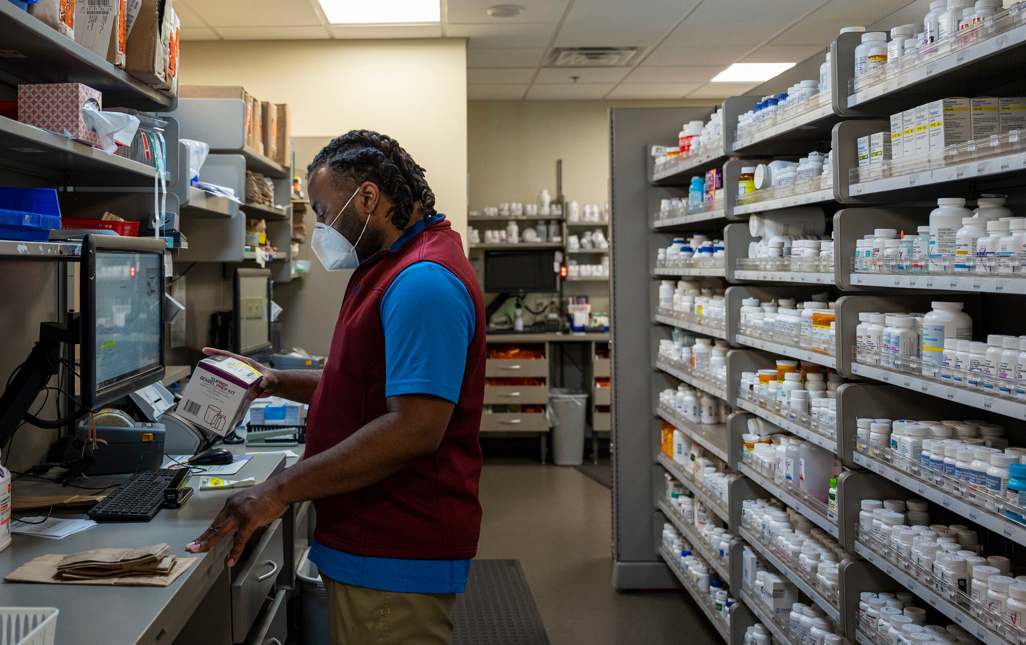 Duane Richardson, 436th Medical Group pharmacist, verifies a prescription at Dover Air Force Base, Delaware, March 17, 2021. On any given day, the pharmacy fills and delivers between 300-1,000 prescriptions. (U.S. Air Force photo by Airman Cydney Lee)