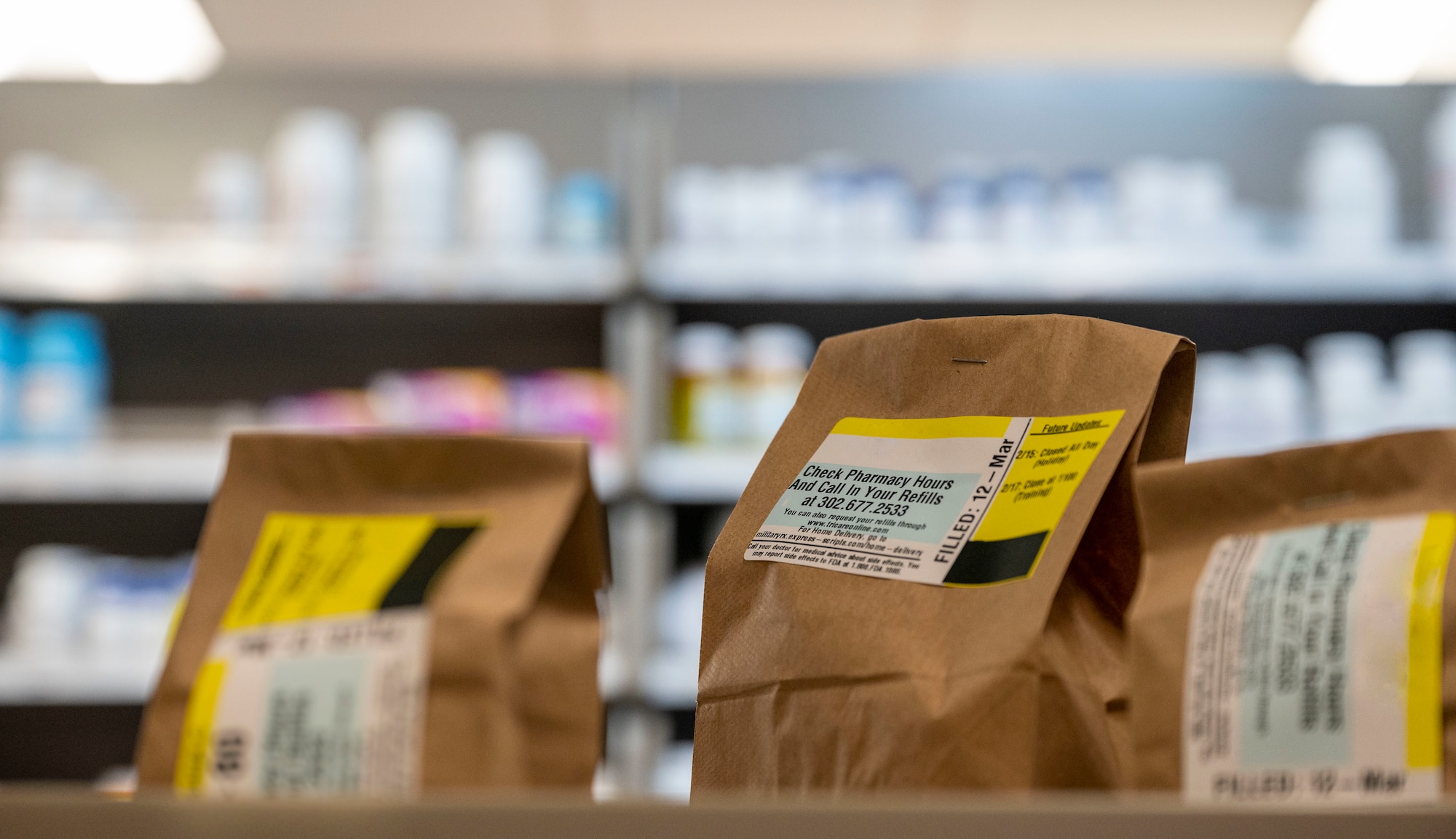 Prescriptions sit on a counter, waiting for delivery in the 436th Medical Group pharmacy at Dover Air Force Base, Delaware, March 12, 2021. On any given day, the pharmacy fills and delivers between 300-1,000 prescriptions. (This photo has been digitally enhanced to protect patient information.) (U.S. Air Force photo by Airman 1st Class Cydney Lee)