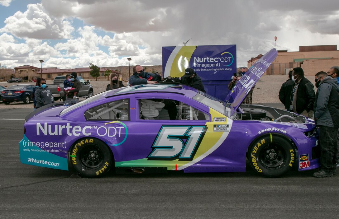 David Snyder, with the Marine Corps Exchange, crawls into the driver’s seat of the #51 car driven by Cody Ware during the 2021 NASCAR Cup Series racing season. The Rick Ware Racing Team visited MCLB Barstow, as well as other installations, as part of its Military Salutes program, March 11.