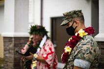 U.S. Marine Corps Col. Speros Koumparakis, commanding officer, Marine Corps Base Hawaii, listens as a prayer is read to bless the newly completed Fairway Inn, MCBH, March 15, 2021. It is Hawaiian tradition to conduct both a blessing and an untying of a Maile Lei at the grand opening to introduce the building to the community and protect it. (U.S. Marine Corps photo by Lance Cpl. Brandon Aultman)