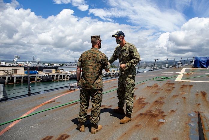 U.S. Marine Corps Brig. Gen. Kyle Ellison, commanding general, 3d Marine Expeditionary Brigade, and deputy commanding general, III Marine Expeditionary Force, is greeted by U.S. Navy Cmdr. DeVere Crooks, commanding officer, Arleigh Burke-class guided-missile destroyer USS Halsey (DDG 97) during a visit aboard Joint Base Pearl Harbor-Hickam, Hawaii, March 12, 2021. Navy and Marine Corps forces teamed up to conduct Exercise Spartan Fury 21.1, which utilizes an integrated operating concept designed to increase efficiency and lethality amongst the naval team and joint force. (U.S. Marine Corps photo by Lance Cpl. Samantha Sanchez)