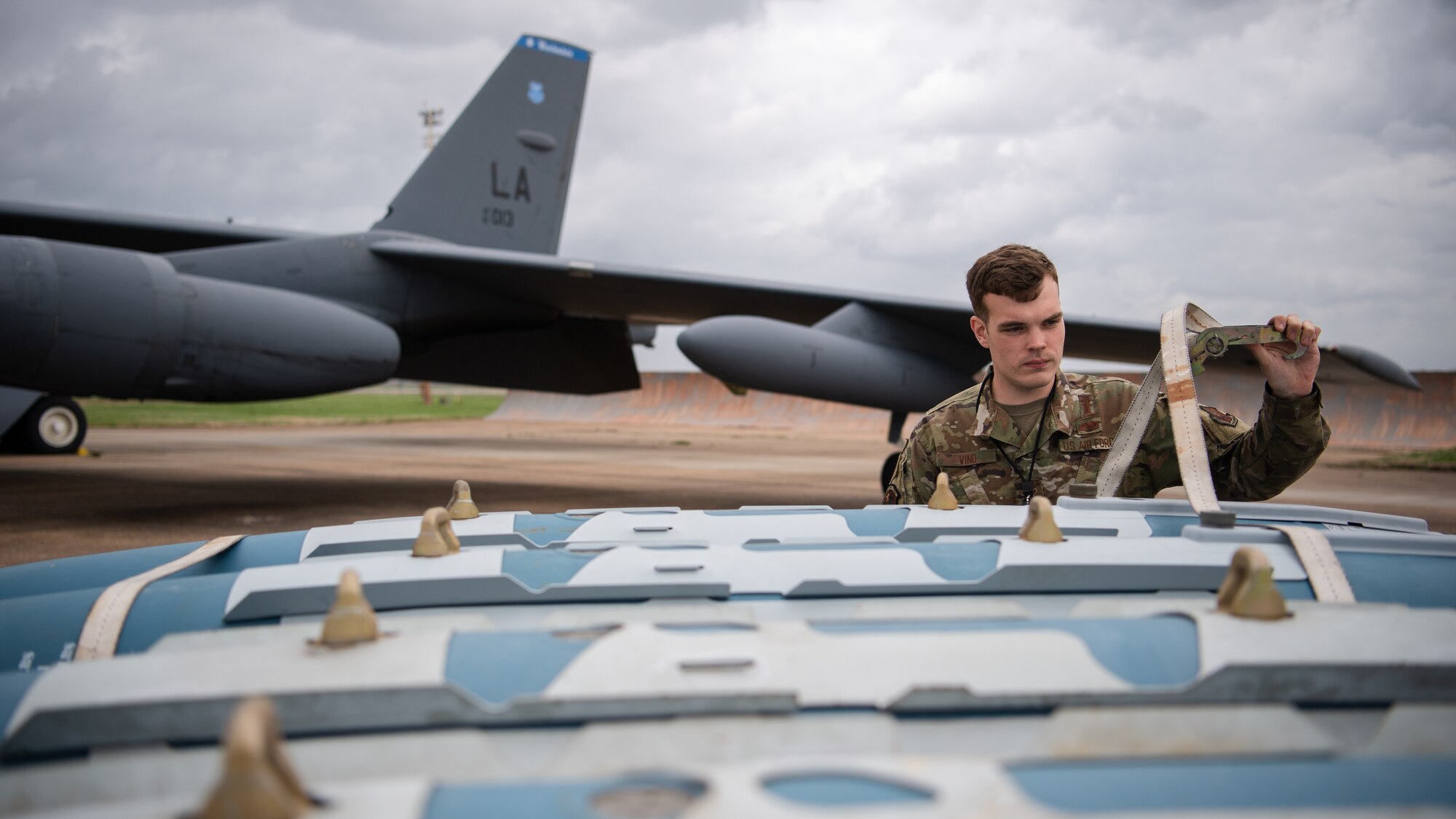 Airman 1st Class Aaron J. Vind, 2nd Aircraft Maintenance Squadron weapons load crew member, unties munitions from a trailer during Combat Hammer at Barksdale Air Force Base, La., Mar. 10, 2021. Combat Hammer was a week-long evaluation of the wing’s capacity to generate, load and employ conventional weapons on target. (U.S. Air Force photo by Airman 1st Class Jacob B. Wrightsman)