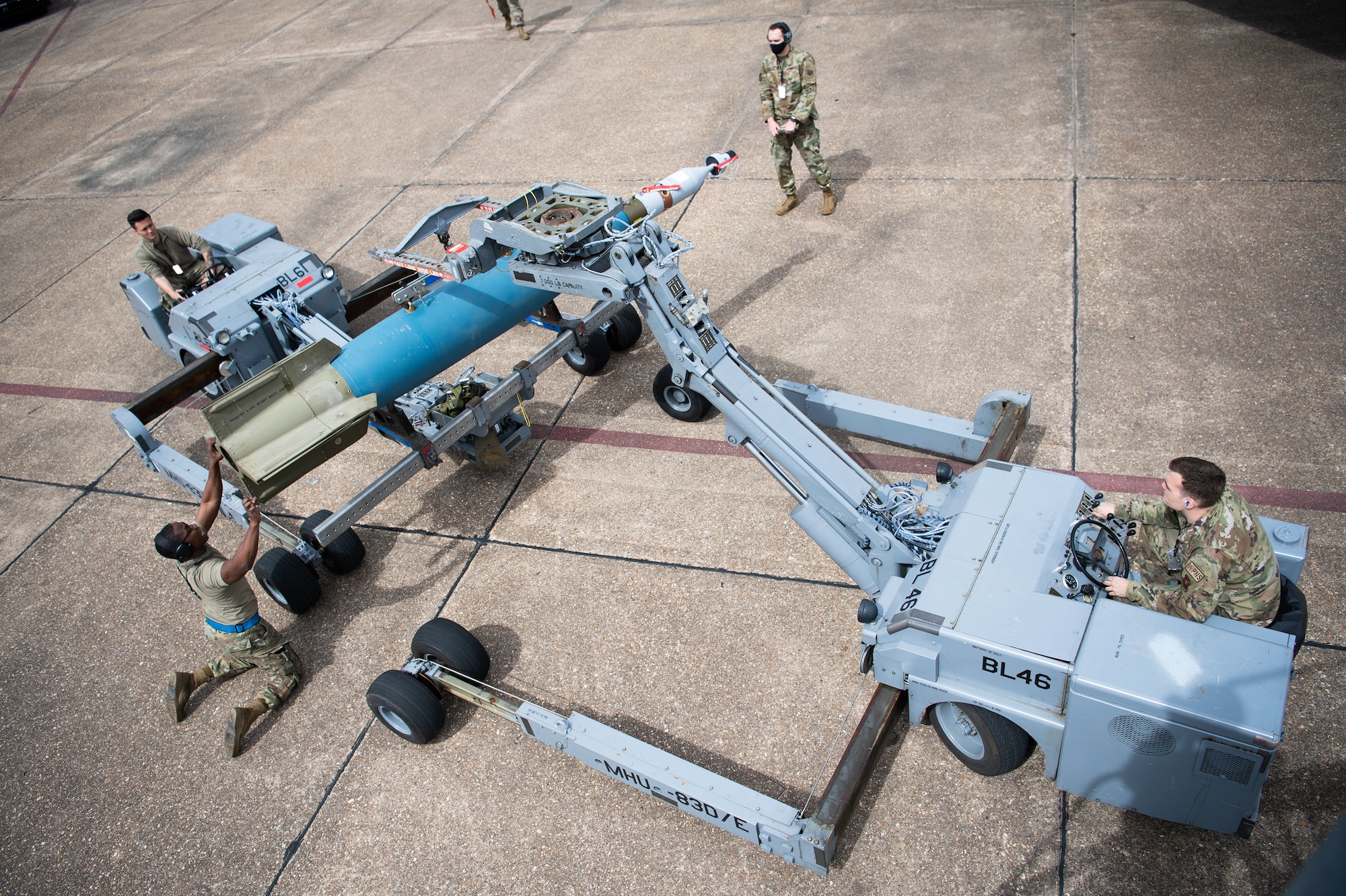 A weapons load crew from the 2nd Aircraft Maintenance Squadron prepare to transport a GBU-10 munition to be loaded onto a B-52H Stratofortress during Combat Hammer at Barksdale Air Force Base, La., March 10, 2021.  Participating in exercises like Combat Hammer is important for Airmen of the 2nd Bomb Wing because it allows all facets of the 2nd BW to get repetitions in generating combat power. (U.S. Air Force photo by Airman 1st Class Jacob B. Wrightsman)