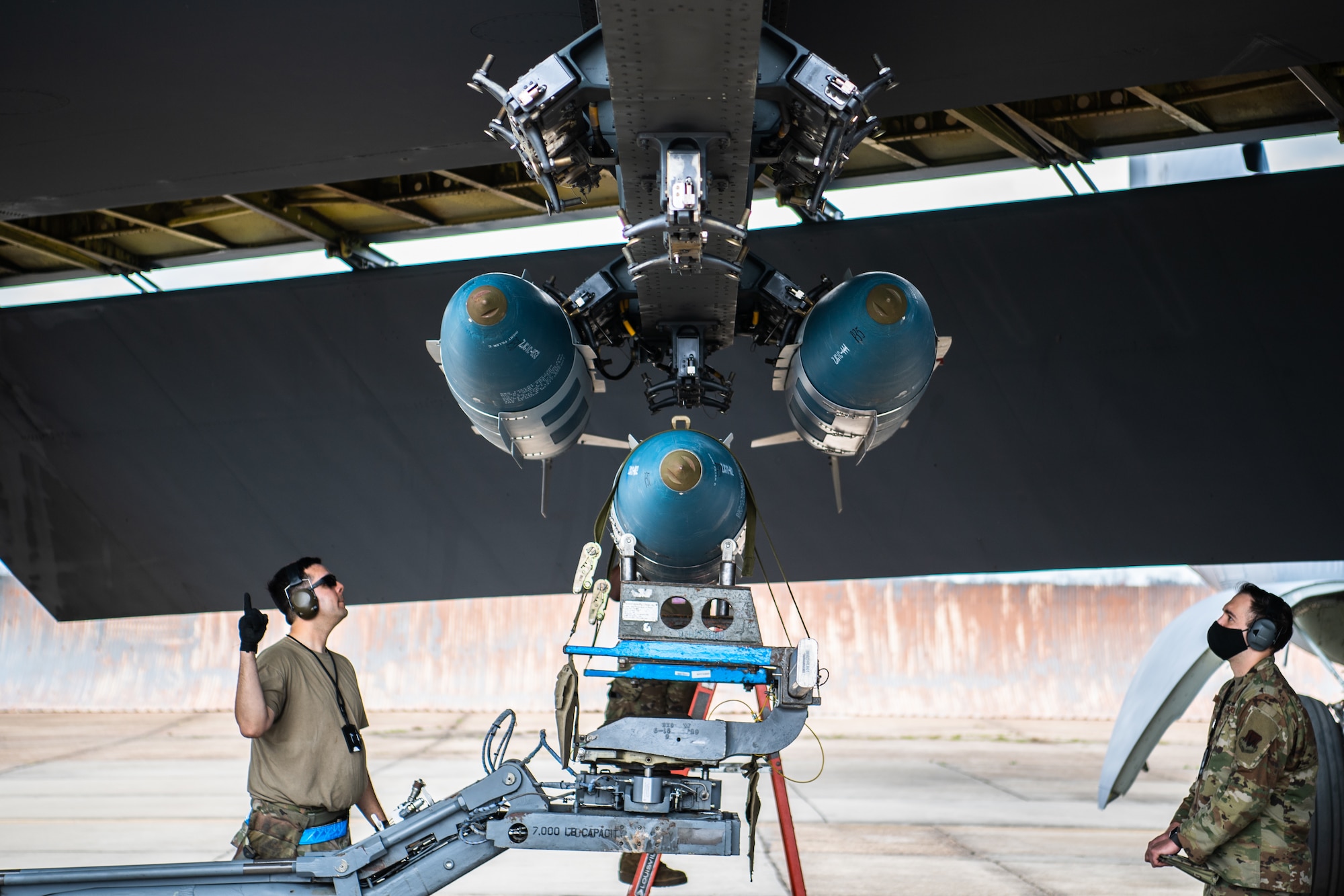 Staff Sgt. Patrick A. Labastida, 2nd Aircraft Maintenance Squadron weapons load crew chief, gives instructions to load a GBU-31 version 1 munition onto a B-52H Stratofortress during Combat Hammer at Barksdale Air Force Base, La., March 10, 2021. Participating in exercises like Combat Hammer is important for Airmen of the 2nd Bomb Wing because it allows all facets of the 2nd BW to get repetitions in generating combat power. (U.S. Air Force photo by Airman 1st Class Jacob B. Wrightsman)