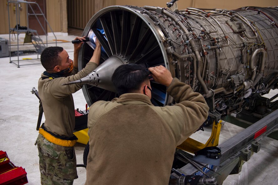 Staff Sgt. Jeremy Ward, left, 314th Aircraft Maintenance Unit assistant dedicated crew chief, and Staff Sgt. Aharon Garcia, 314th AMU Aerospace Propulsion craftsman, repair blade damage on an F-16 Viper engine, March 5, 2021, on Holloman Air Force Base, New Mexico. Ward and Garcia helped switch out a serviceable engine from one F-16 to another in preparation for the temporary duty assignment to Tyndall AFB, Florida for the Weapons System Evaluation Program. (U.S. Air Force photo by Airman 1st Class Quion Lowe)