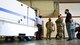 Brig. Gen. Eric H. Froehlich, arms folded, Air Force Global Strike Command director of logisitcs and engineering, takes a tour of the recently acquired E-4B ground power unit at Barksdale Air Force Base, Louisiana, March 17, 2021. The power unit will be used to give power to E-4B aircraft that occasionally stop at Barksdale. (U.S. Air Force photo by Airman 1st Class Jacob B. Wrightsman)