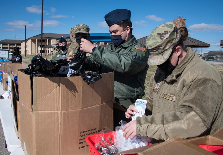 Members assemble welcome bags at the Armed Services YMCA (ASYMCA) of Altus Air Force Base open house drive-thru event at Altus AFB, Oklahoma, March 18, 2021. Members handed out welcome bags for single Airmen, families and families with babies. (U.S. Air Force photo by Airman 1st Class Amanda Lovelace)