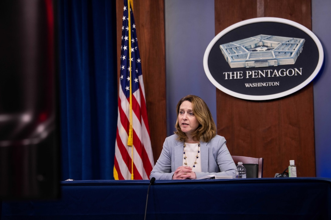 Deputy Defense Secretary Kathleen H. Hicks sits and speaks at a table.