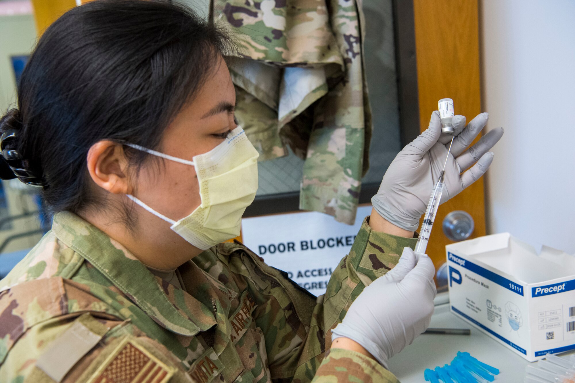 U.S. Air Force 1st Lt. Rylyn Kinoshita with the 624th Aeromedical Staging Squadron prepares a COVID-19 vaccine at Joint Base Pearl Harbor-Hickam, Hawaii, March 7, 2021, during the Unit Training Assembly.