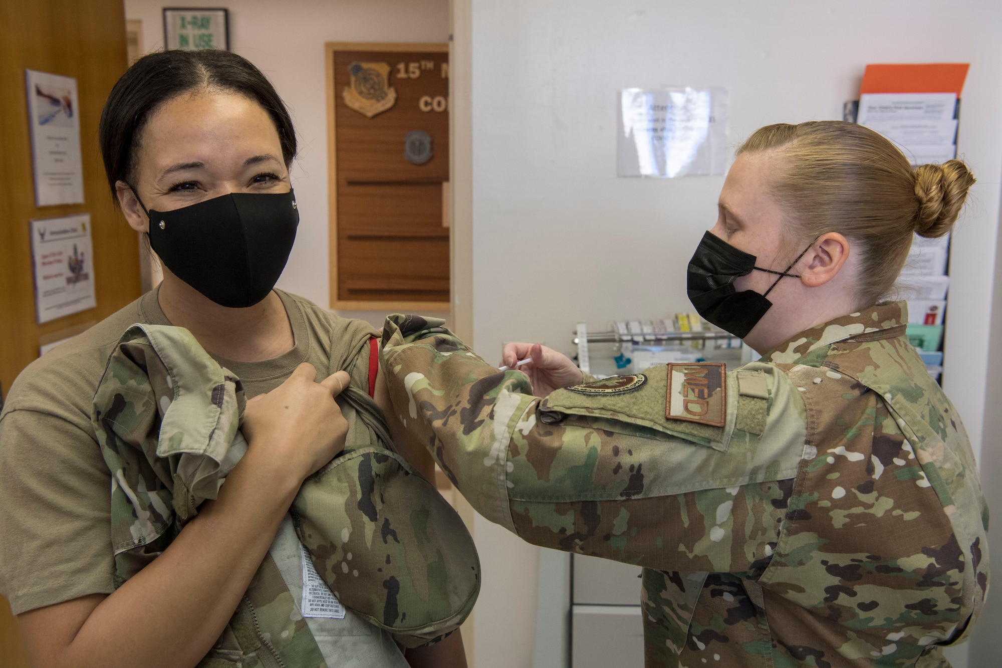 U.S. Air Force Senior Master Sgt. Lacey Sterling with the 624th Aeromedical Staging Squadron administers a COVID-19 vaccine to Master Sgt. Amber Burks at Joint Base Pearl Harbor-Hickam, Hawaii, March 7, 2021, during a Unit Training Assembly.