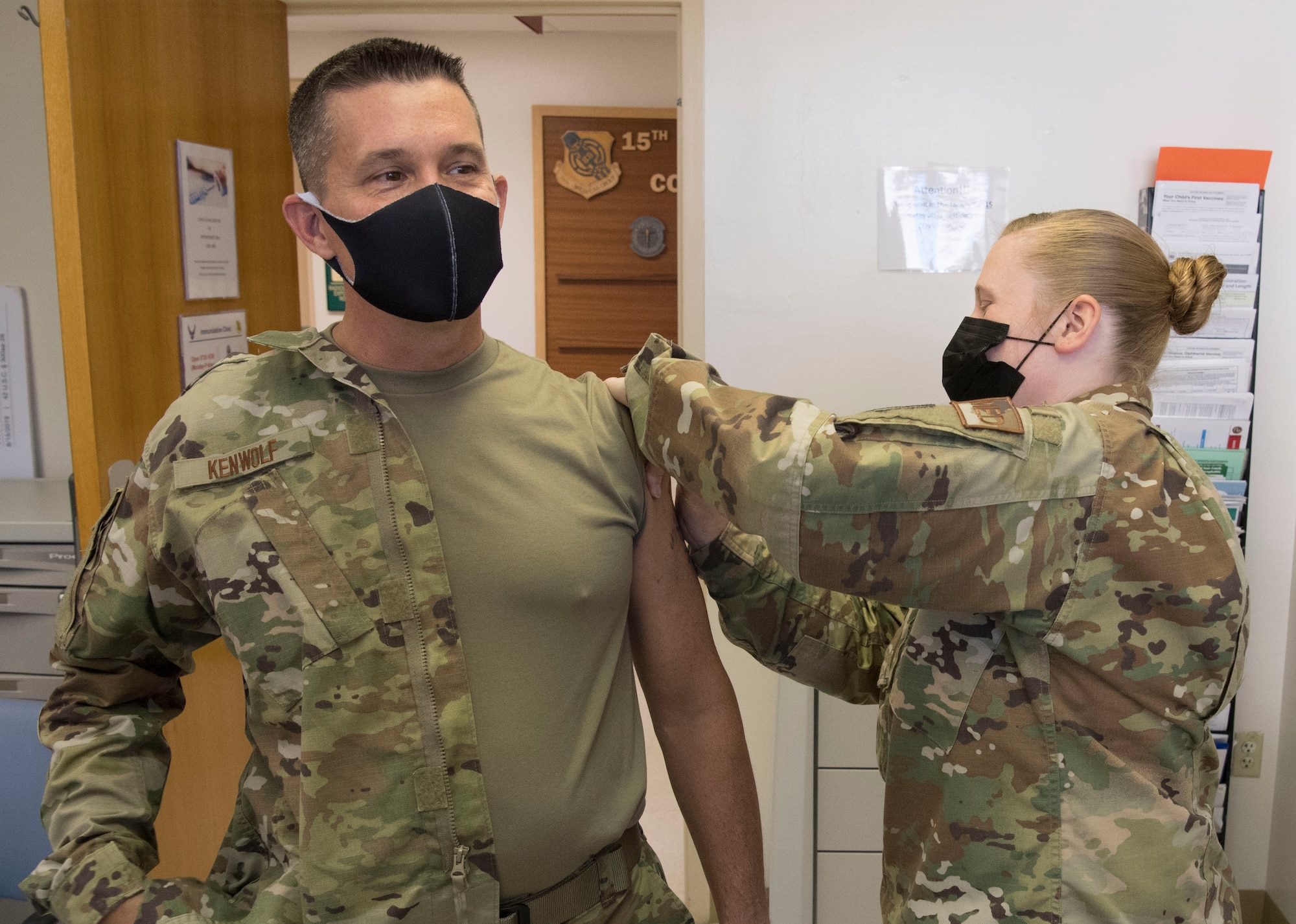 U.S. Air Force Senior Master Sgt. Lacey Sterling, with the 624th Aeromedical Staging Squadron administers a COVID-19 vaccine to Air Force Chief Master Sgt. James Kenwolf at Joint Base Pearl Harbor-Hickam, Hawaii, March 7, 2021, during the Unit Training Assembly.