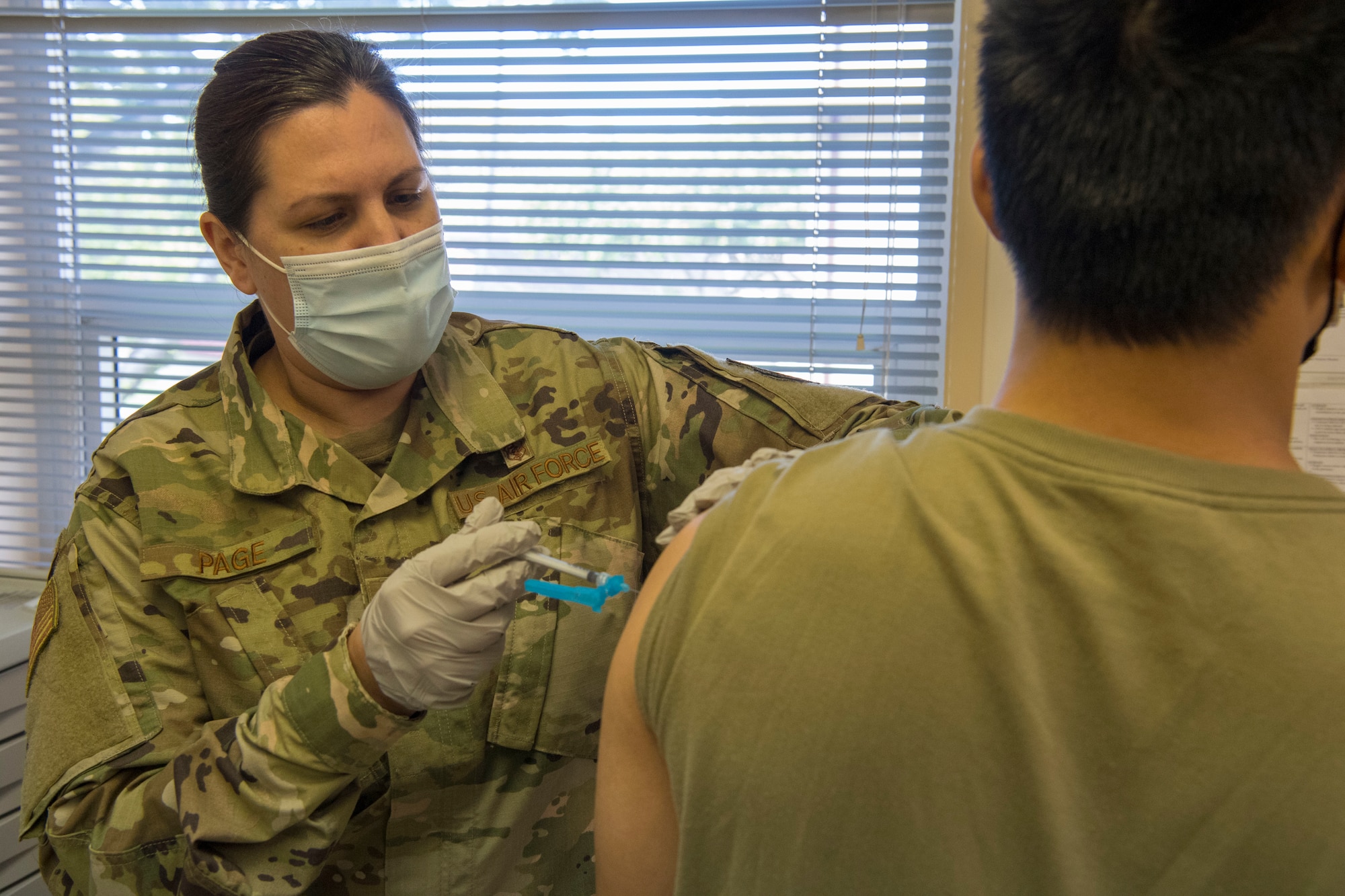 U.S. Air Force Capt. Kathleen Page with the 624th Aeromedical Staging Squadron administers a COVID-19 vaccine at Joint Base Pearl Harbor-Hickam, Hawaii, March 7, 2021, during the Unit Training Assembly.