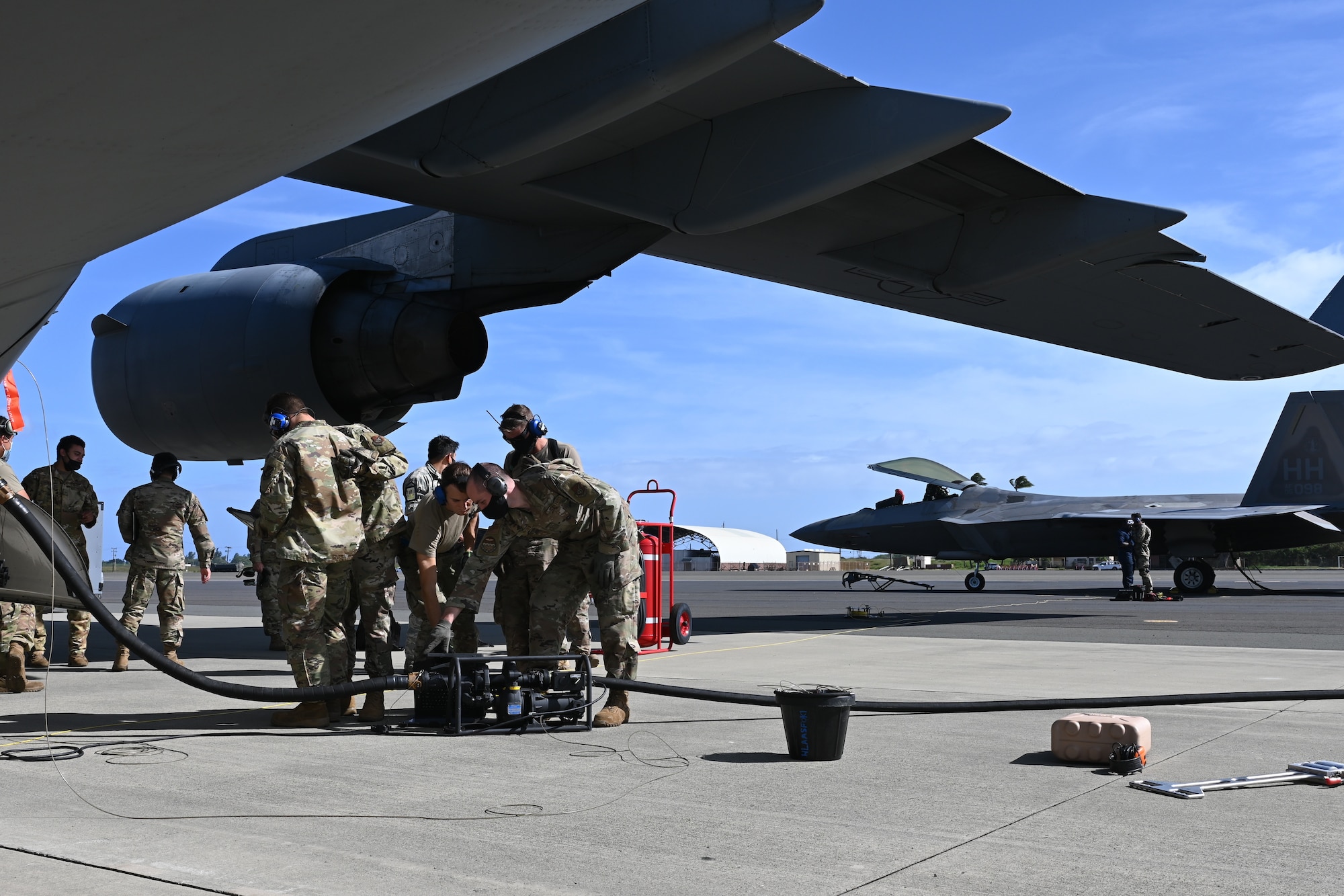 An F-22 Raptor receives fuel from a C-17 Globemaster III on the flightline of Joint Base Pearl Harbor-Hickam, Feb. 25, 2021.