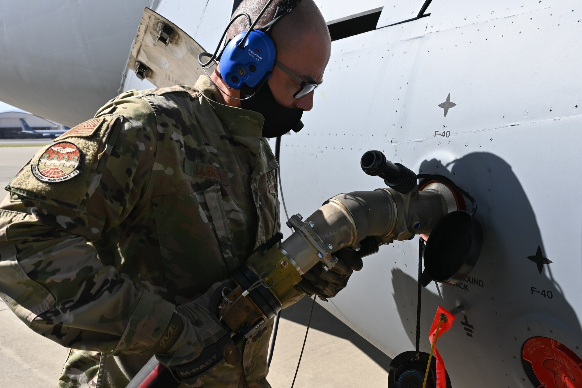 Senior Airman Samuel Lugo, 15th Aircraft Maintenance Squadron C-17 crew chief, attaches a refueling hose to a C-17 Globemaster III , Feb. 25, 2021, Joint Base Pearl Harbor-Hickam.