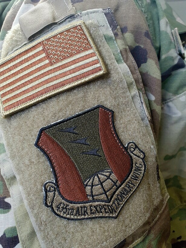 A U.S. Air Force Airman wears the 435th Air Expeditionary Wing patch at Ramstein Air Base, Germany, March 19, 2021. The 435 AEW provides combat Airpower and base operating support for operations across Africa. The 435 AEW’s continued success relies on commanders and first line supervisor’s ability to recruit, develop and retain individuals committed to the profession of arms and Air Force core values. (Courtesy photo)