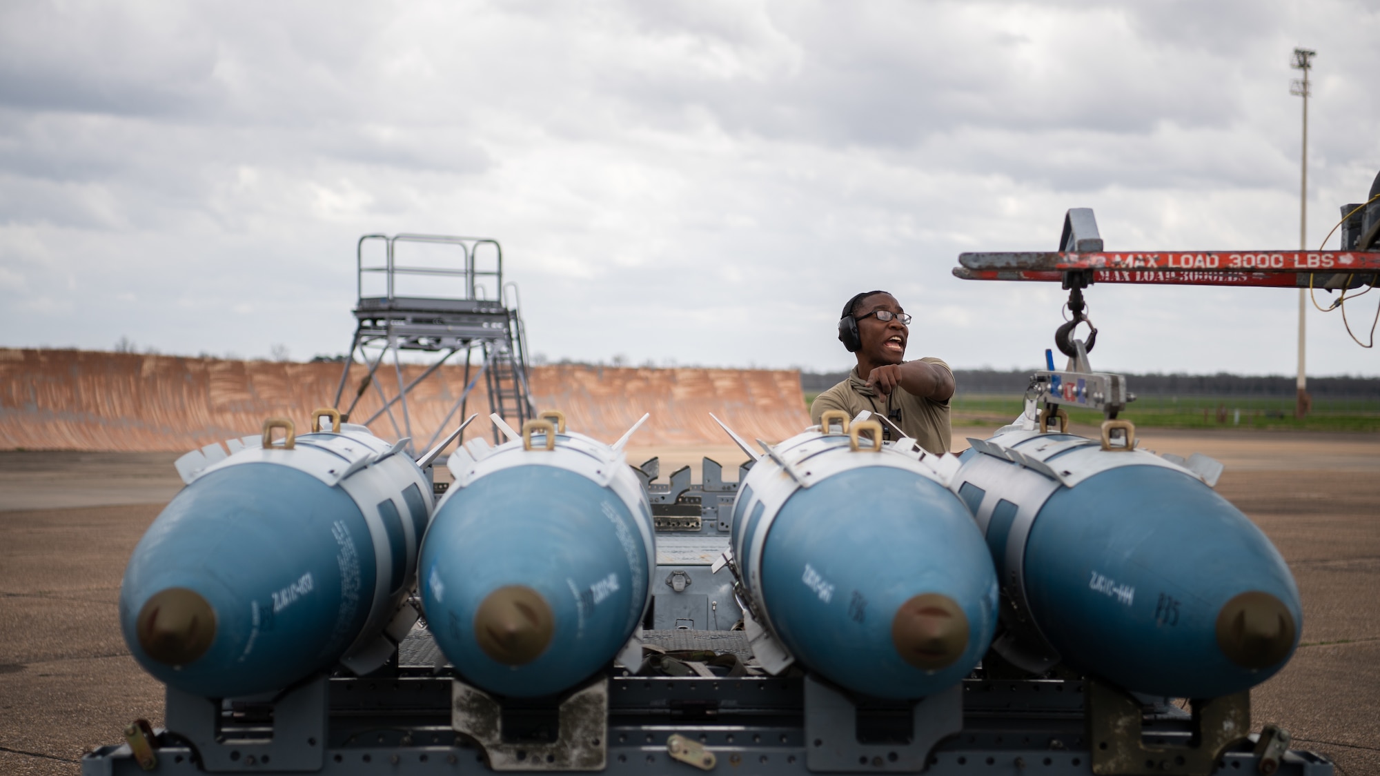 Senior Airman Christian X. Brewer, 2nd Aircraft Maintenance Squadron weapons load crew member, yells instructions in order to load munitions onto a B-52H Stratofortress during Combat Hammer at Barksdale Air Force Base, La., March 10, 2021. Airmen from the 2nd Bomb Wing flew an impressive eight for eight sortie generation and fly rate, something rarely seen across all combat platforms, not just bombers in support of the exercise. (U.S. Air Force photo by Airman 1st Class Jacob B. Wrightsman)