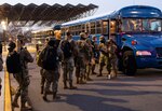 Airmen from the 88th Medical Group board a bus outside the medical center as they deploy from Wright-Patterson Air Force Base, Ohio, to Detroit, Michigan, March 19, 2021 in support of the Federal Emergency Management whole-of-government COVID response. During their deployment members will setup a COVID-19 vaccination site where they could vaccinate as many as 6,000 people a day. (U.S. Air Force photo by Wesley Farnsworth)