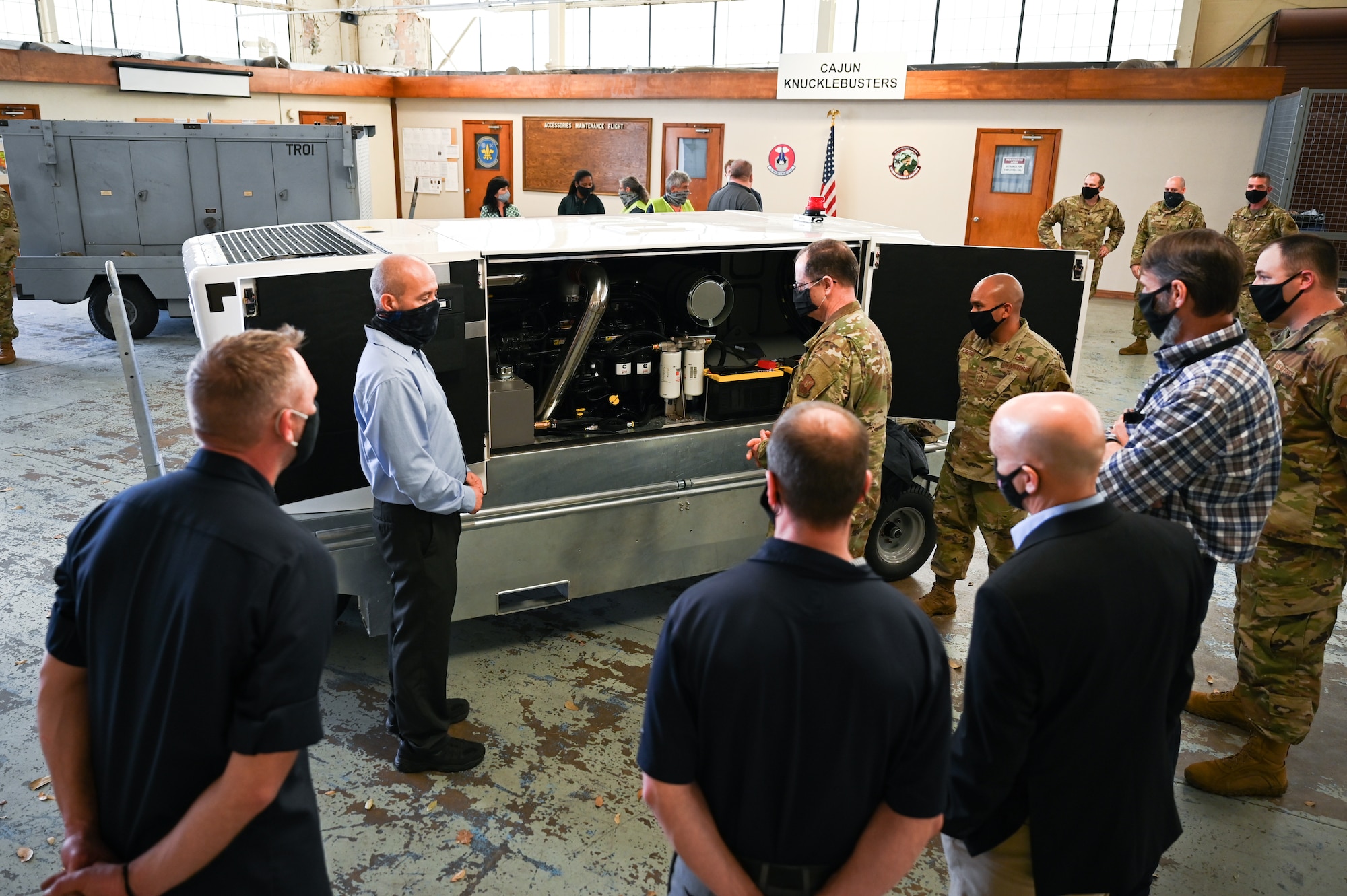 Brig. Gen. Eric H. Froehlich, center, Air Force Global Strike Command director of logistics and engineering, takes a tour of the recently acquired E-4B ground power unit at Barksdale Air Force Base, Louisiana, March 17, 2021. The power unit will be used to give power to E-4B aircraft that occasionally stop at Barksdale. (U.S. Air Force photo by Airman 1st Class Jacob B. Wrightsman)