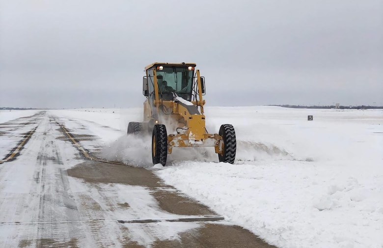 An Airman from the 7th Bomb Wing clears a path on the flightline at Dyess Air Force Base, Texas,  February 19th 2021.