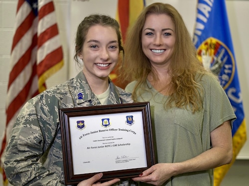 Cadet Audra Lindquist, a senior at Shadow Mountain High School, Phoenix, AZ, Air Force Junior ROTC Unit AZ-911, is congratulated by her mother, Amira Keuhn, aerospace instructors and school leadership for being a recipient of The J-100 AFJROTC Character-in-Leadership Scholarship.