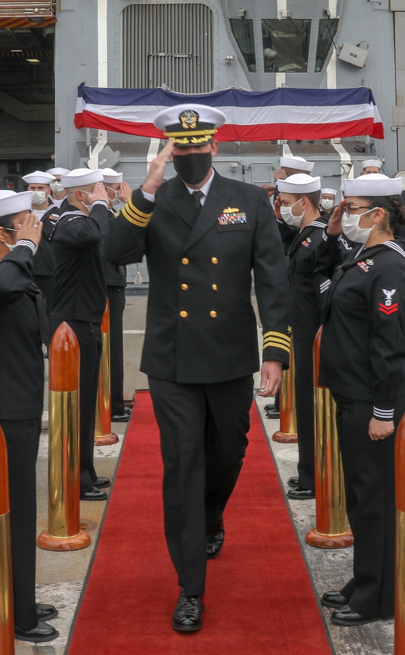 YOKOSUKA, Japan (March 19, 2021) Cmdr. Robert J. Briggs is greeted during a change of command ceremony aboard the Arleigh-Burke class guided-missile destroyer USS Mustin (DDG 89) while in port at Naval Base Yokosuka. (US Navy photo by Mass Communication Specialist 3rd Class Arthur Rosen)