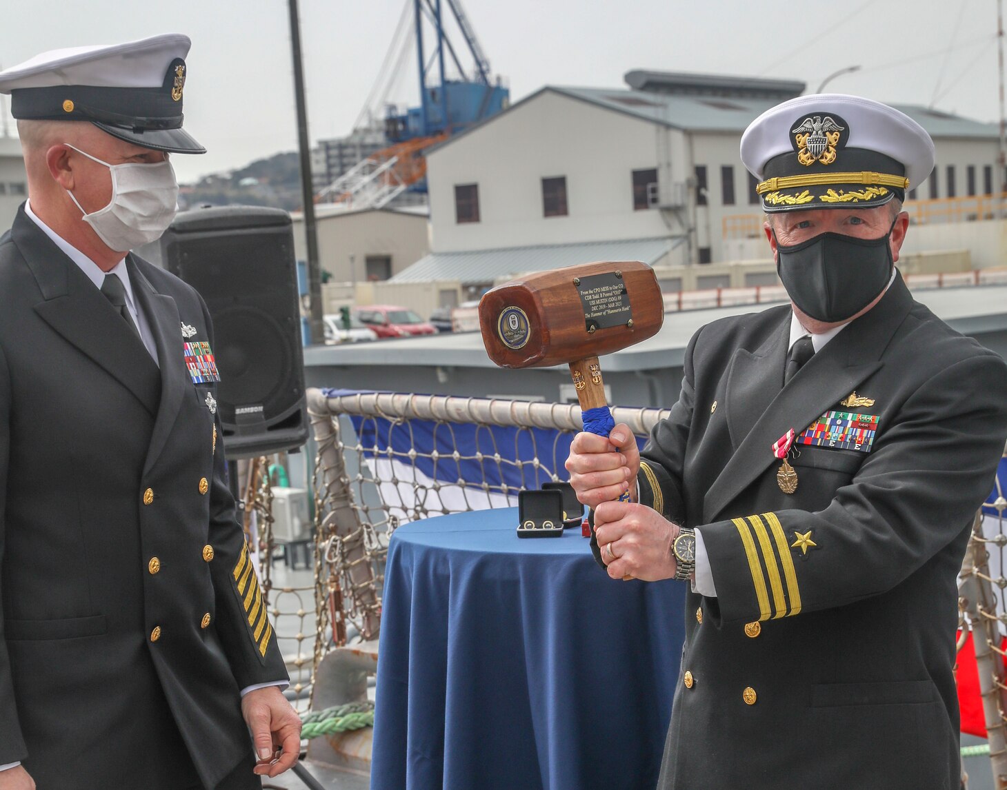 YOKOSUKA, Japan (March 19, 2021) Cmdr. Todd Penrod receives gifts from the Chief's Mess of the  Arleigh-Burke class guided-missile destroyer USS Mustin (DDG 89) during a change of command ceremony aboard  Mustin while in port at Naval Base Yokosuka. (US Navy photo by Mass Communication Specialist 3rd Class Arthur Rosen)